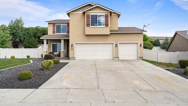 5801 Thistledown Dr, Pasco, WA 99301 - traditional-style house with a garage, driveway, and stucco siding