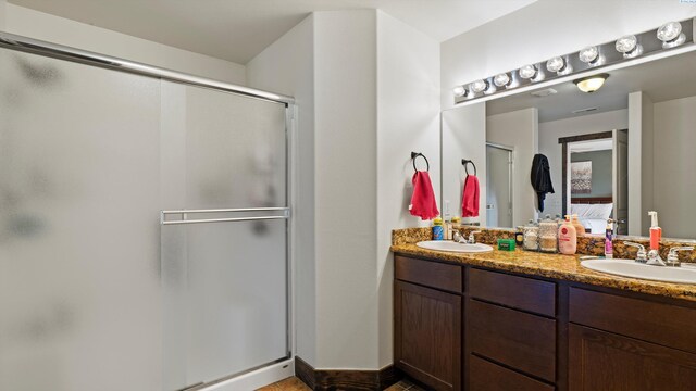 5801 Thistledown Dr, Pasco, WA 99301 - bathroom with a stall shower, double vanity, ensuite bathroom, and baseboards