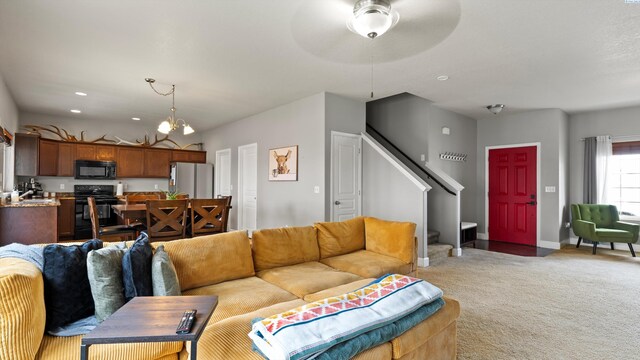 5801 Thistledown Dr, Pasco, WA 99301 - living room featuring carpet flooring, stairway, a ceiling fan, and baseboards