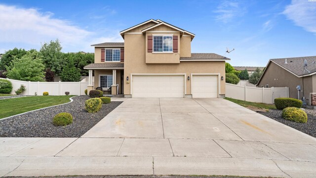 5801 Thistledown Dr, Pasco, WA 99301 - traditional-style home featuring a garage, driveway, and stucco siding