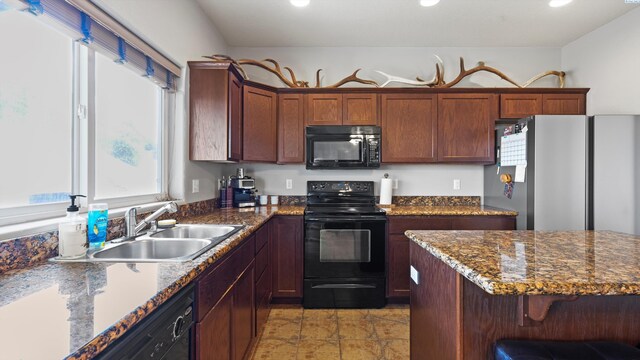 5801 Thistledown Dr, Pasco, WA 99301 - kitchen featuring black appliances, a sink, recessed lighting, a kitchen breakfast bar, and dark stone counters