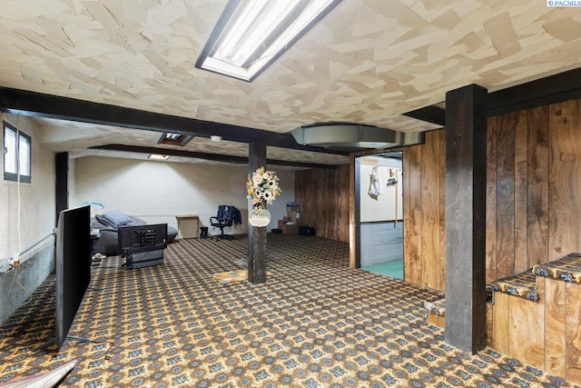 basement featuring wooden walls