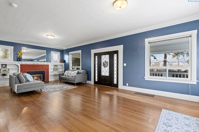 entryway with crown molding, plenty of natural light, and wood-type flooring