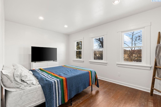 bedroom with dark wood-type flooring