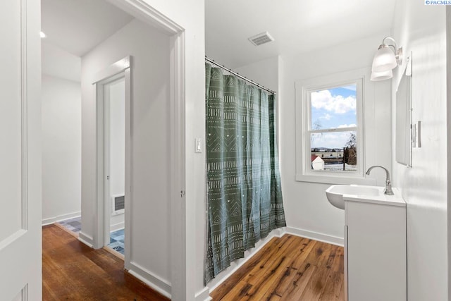 bathroom with vanity and hardwood / wood-style floors