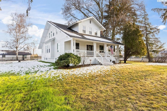 view of front of home with a porch and a front yard