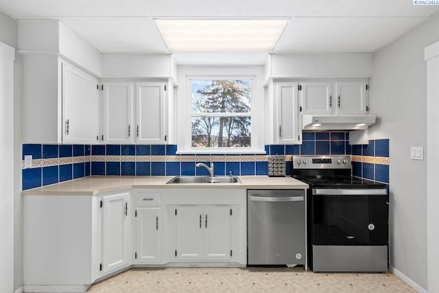 kitchen with white cabinetry, appliances with stainless steel finishes, sink, and backsplash