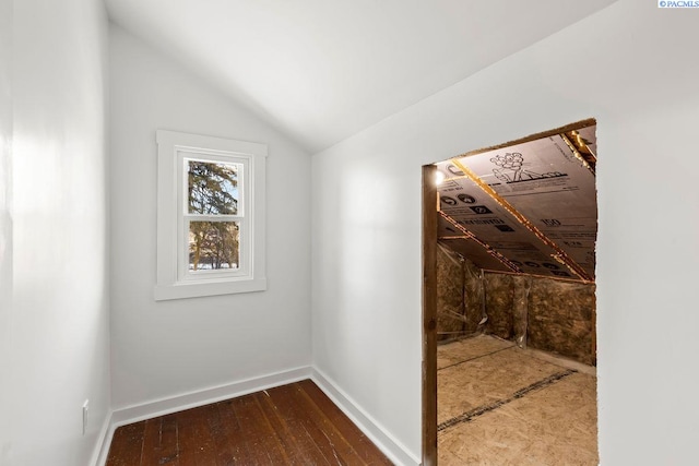 interior space with hardwood / wood-style flooring and vaulted ceiling