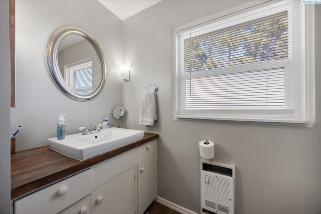 bathroom with vanity and heating unit