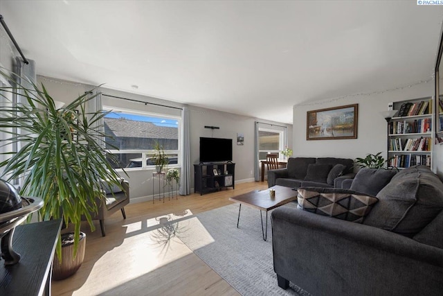 living room featuring baseboards and wood finished floors