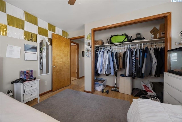 bedroom with ceiling fan, a closet, and wood finished floors