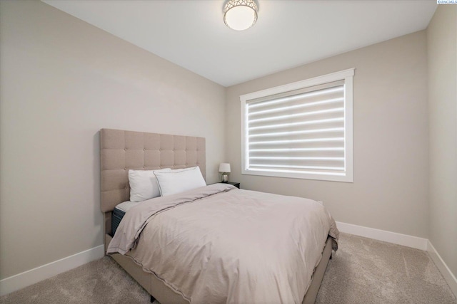 bedroom featuring lofted ceiling, carpet flooring, and baseboards