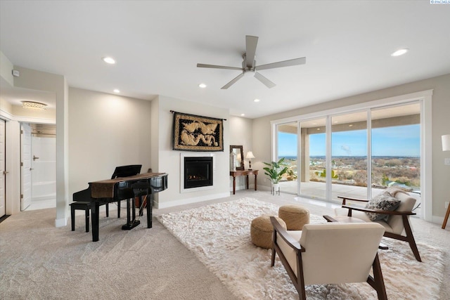 living area with recessed lighting, a fireplace, and light colored carpet