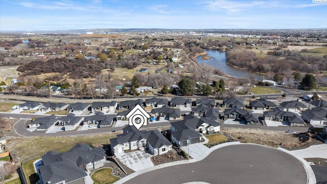 drone / aerial view with a residential view and a water view