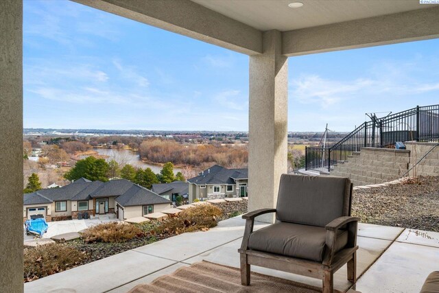 view of patio with a residential view and stairway