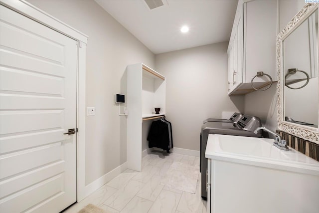 washroom featuring washing machine and dryer, visible vents, baseboards, marble finish floor, and cabinet space