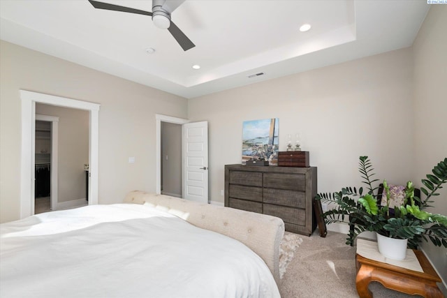 carpeted bedroom featuring recessed lighting, a raised ceiling, visible vents, and ceiling fan