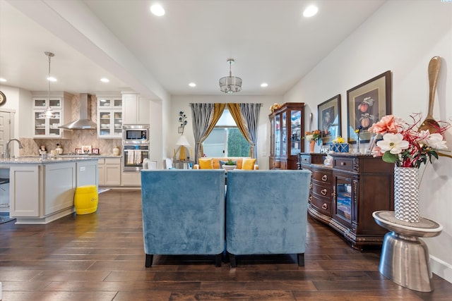 living room with dark hardwood / wood-style flooring and sink