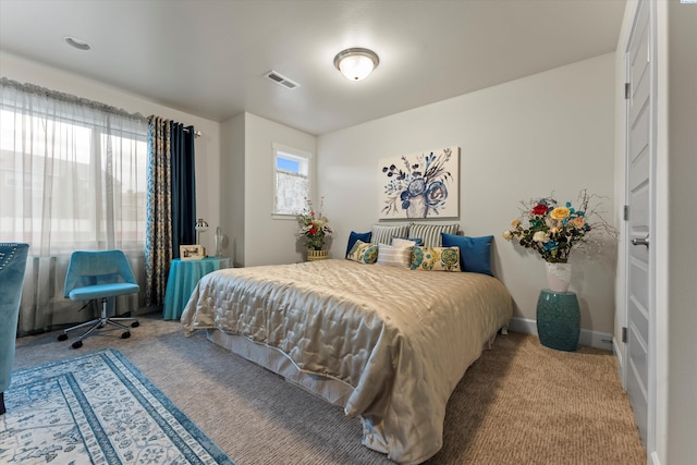 bedroom with carpet and multiple windows