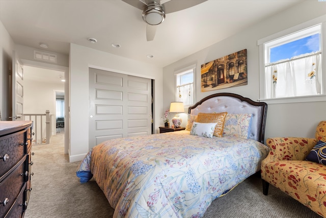 carpeted bedroom with ceiling fan and a closet