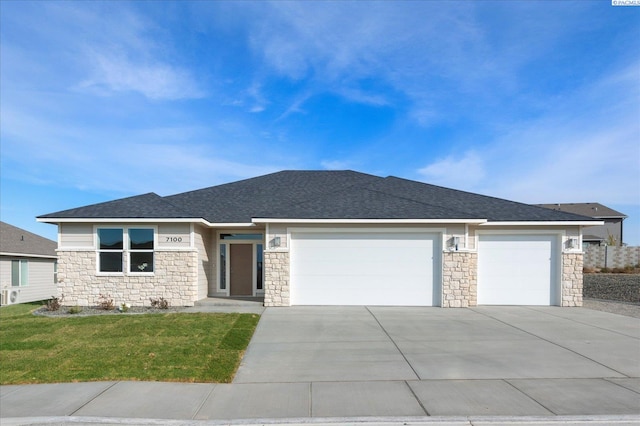 view of front of home featuring a garage and a front lawn