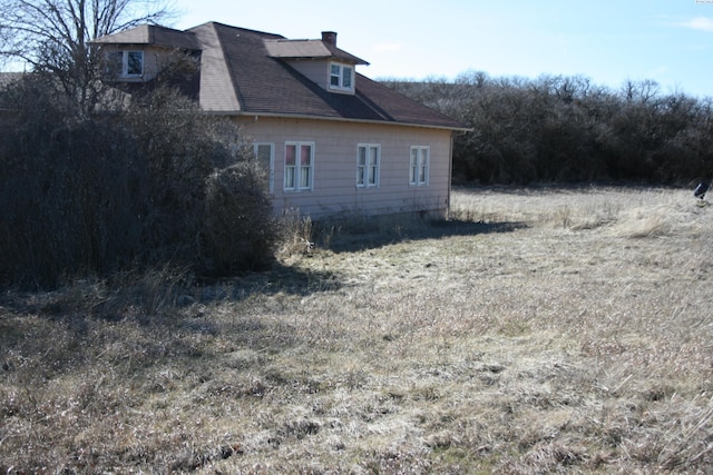 view of side of property with a chimney