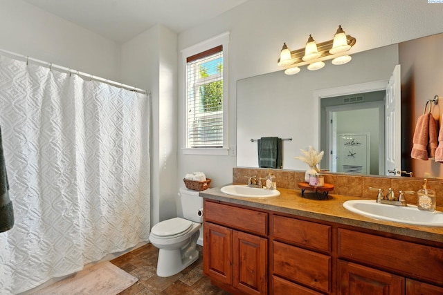 6117 Dorchester Ct, Pasco, WA 99301 - full bath with stone finish floors, double vanity, toilet, and curtained shower