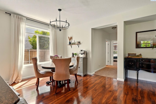 6117 Dorchester Ct, Pasco, WA 99301 - dining area with a chandelier, dark wood-style flooring, and baseboards