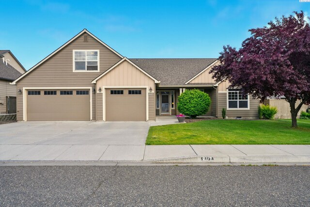 6117 Dorchester Ct, Pasco, WA 99301 - view of front of home with board and batten siding, a front yard, driveway, an attached garage, and roof with shingles