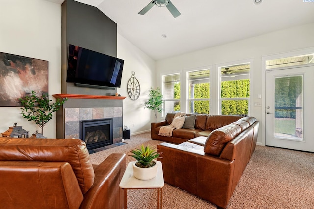 6117 Dorchester Ct, Pasco, WA 99301 - carpeted living room featuring ceiling fan, a tiled fireplace, baseboards, and high vaulted ceiling