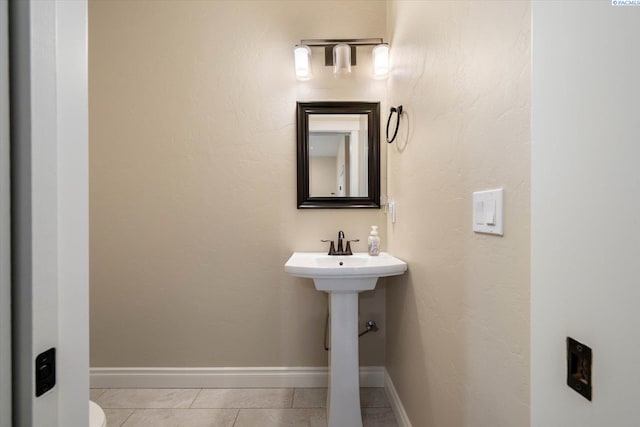 bathroom with tile patterned flooring and baseboards