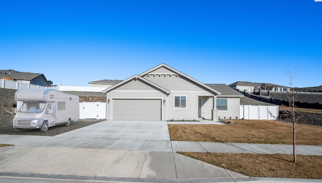 view of front of property featuring a garage and a front lawn