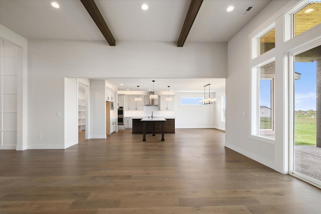 living room with recessed lighting, dark wood-style floors, and beamed ceiling