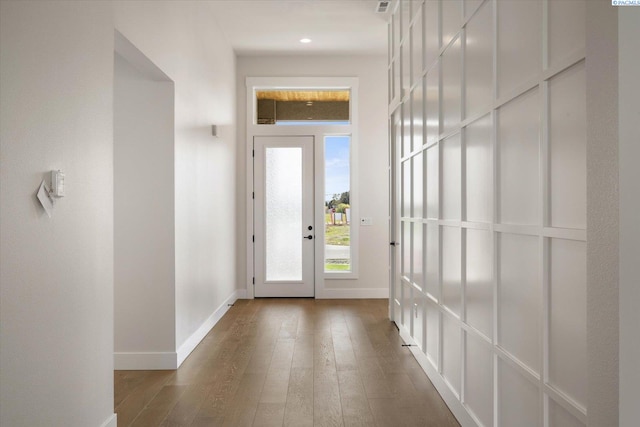 doorway with hardwood / wood-style floors and baseboards