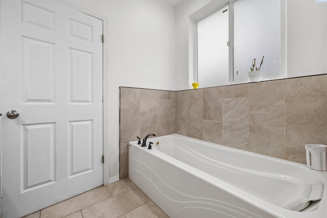 bathroom featuring a garden tub and tile patterned floors