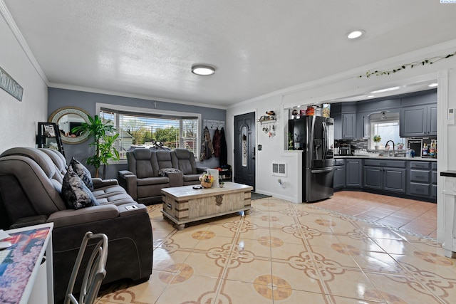 living area with baseboards, a textured ceiling, ornamental molding, and light tile patterned floors