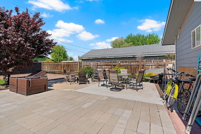 view of patio featuring outdoor dining area and a fenced backyard