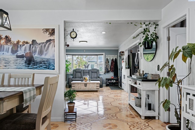 living room with light tile patterned flooring and a textured ceiling