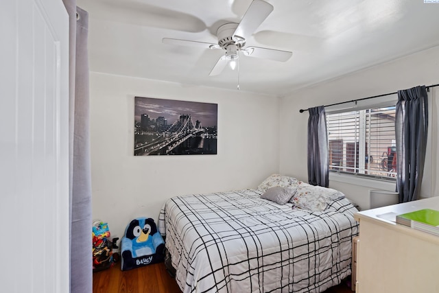 bedroom with a ceiling fan and wood finished floors