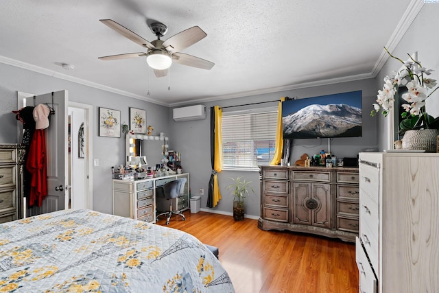 bedroom featuring ceiling fan, a wall unit AC, crown molding, baseboards, and light wood-style floors