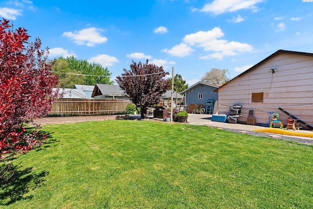 view of yard featuring fence and a patio area