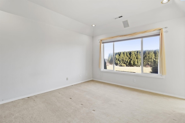 unfurnished room featuring light carpet