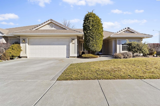 single story home with a garage and a front lawn