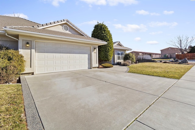 ranch-style house with a garage and a front yard