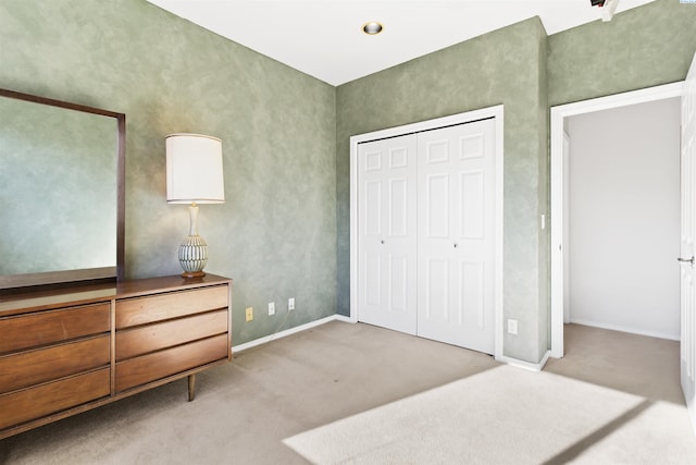 bedroom with light carpet and a closet