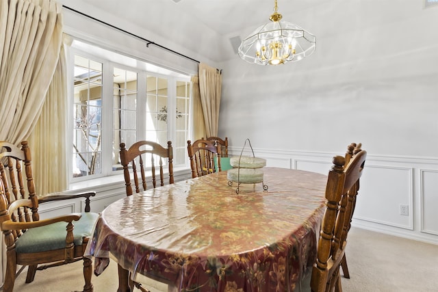 dining space with light carpet, a notable chandelier, french doors, and a healthy amount of sunlight