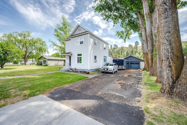 1804 Cedar St, Colfax, WA 99111 - view of front of property featuring a front yard, an outbuilding, a detached garage, and driveway