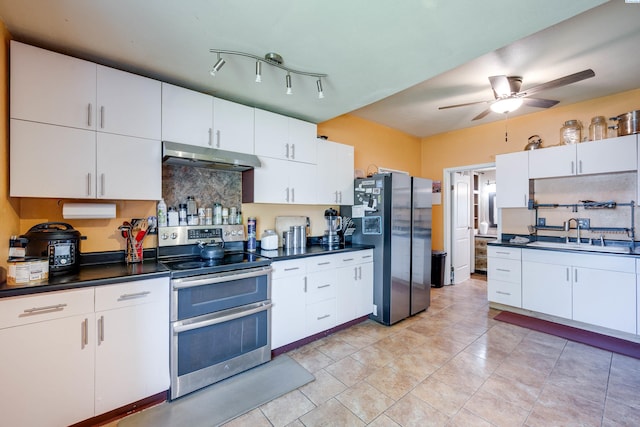1804 Cedar St, Colfax, WA 99111 - kitchen featuring stainless steel appliances, under cabinet range hood, dark countertops, tasteful backsplash, and ceiling fan
