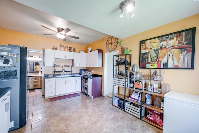 1804 Cedar St, Colfax, WA 99111 - kitchen featuring freestanding refrigerator, ceiling fan, fridge, white cabinetry, and dark countertops