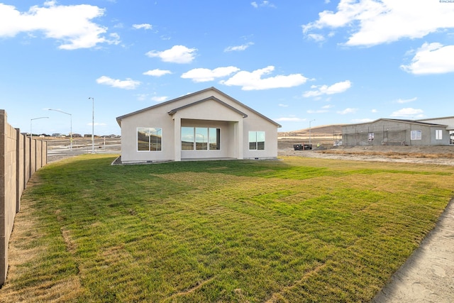 back of property featuring a lawn